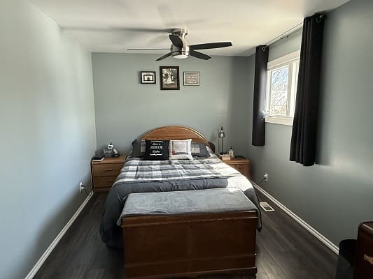 Cozy bedroom with gray walls and bedding.