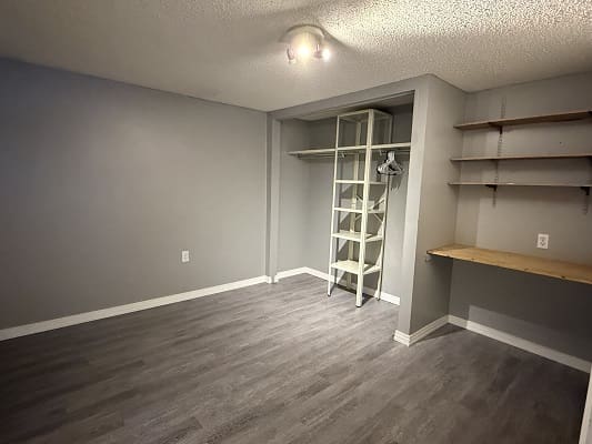 Empty room with shelves and closet space.