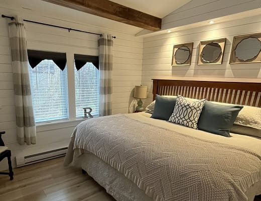 Cozy bedroom with stylish decor and bedding.