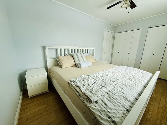 Minimalist bedroom with bed and nightstand.