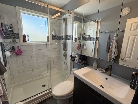 Modern bathroom with glass shower enclosure.
