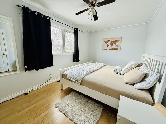 Cozy bedroom with bed and world map.