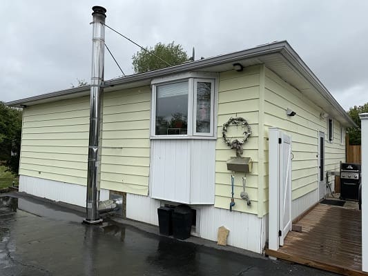 Small yellow house with a chimney.