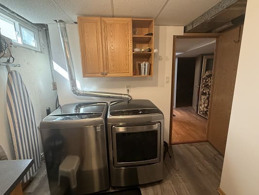 Laundry room with washer and dryer units.