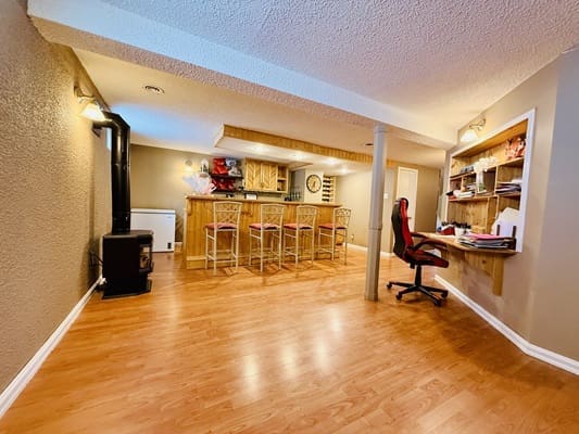 Basement room with bar and desk area.