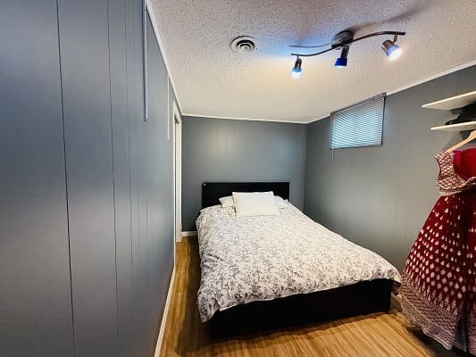 Cozy bedroom with gray walls and bed.