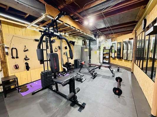 Home gym with various fitness equipment.