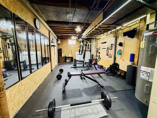 Home gym with various exercise equipment.