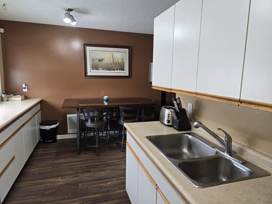 Modern kitchen with sink and dining table.