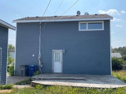 Blue house with white door and windows.