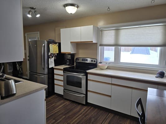 Modern kitchen with stainless steel appliances.