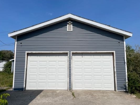 Blue garage with two white doors.