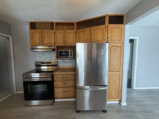 Modern kitchen with stainless steel appliances.