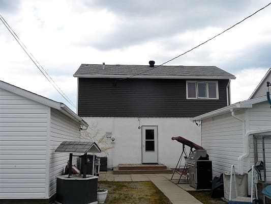 Backyard view of a two-story house.