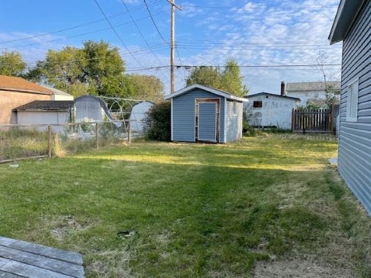 Backyard with shed and grassy area.
