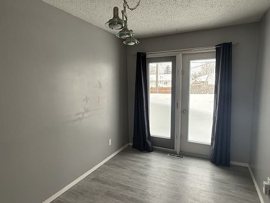 Empty room with gray walls and curtains.