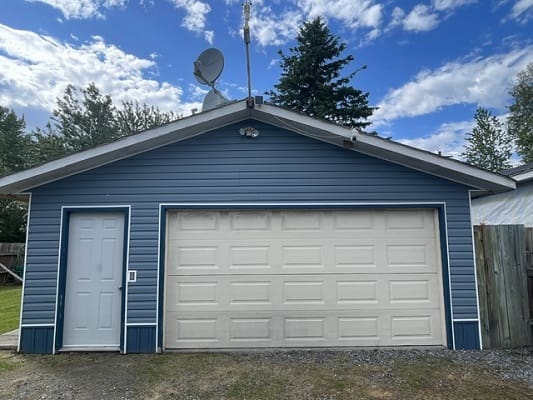 Blue detached garage with satellite dish